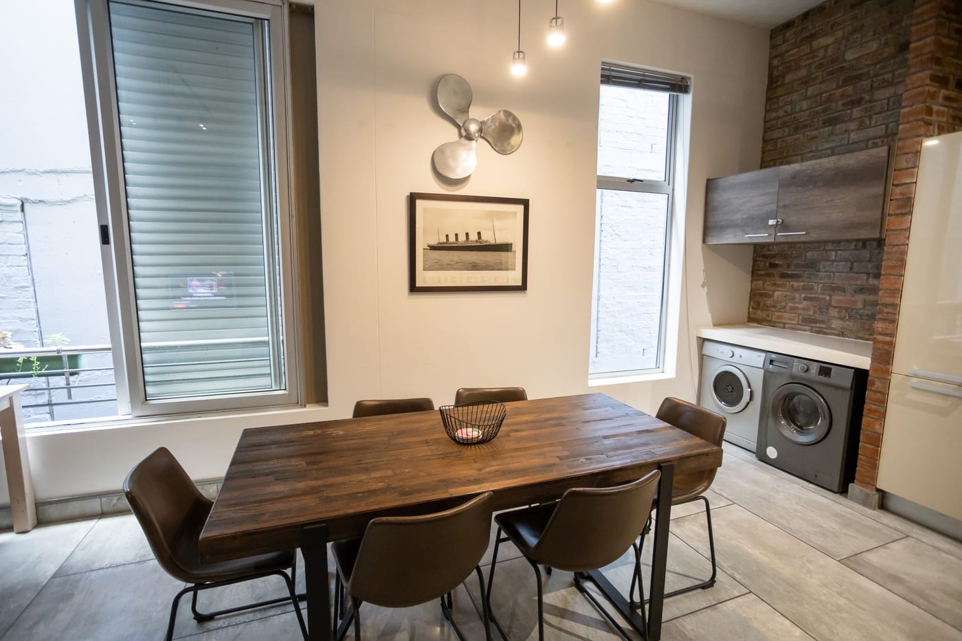Dining table beside the kitchen and laundry area