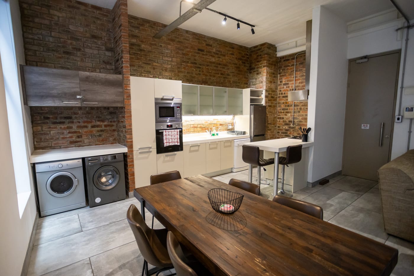 Kitchen and laundry area in the Gardens apartment