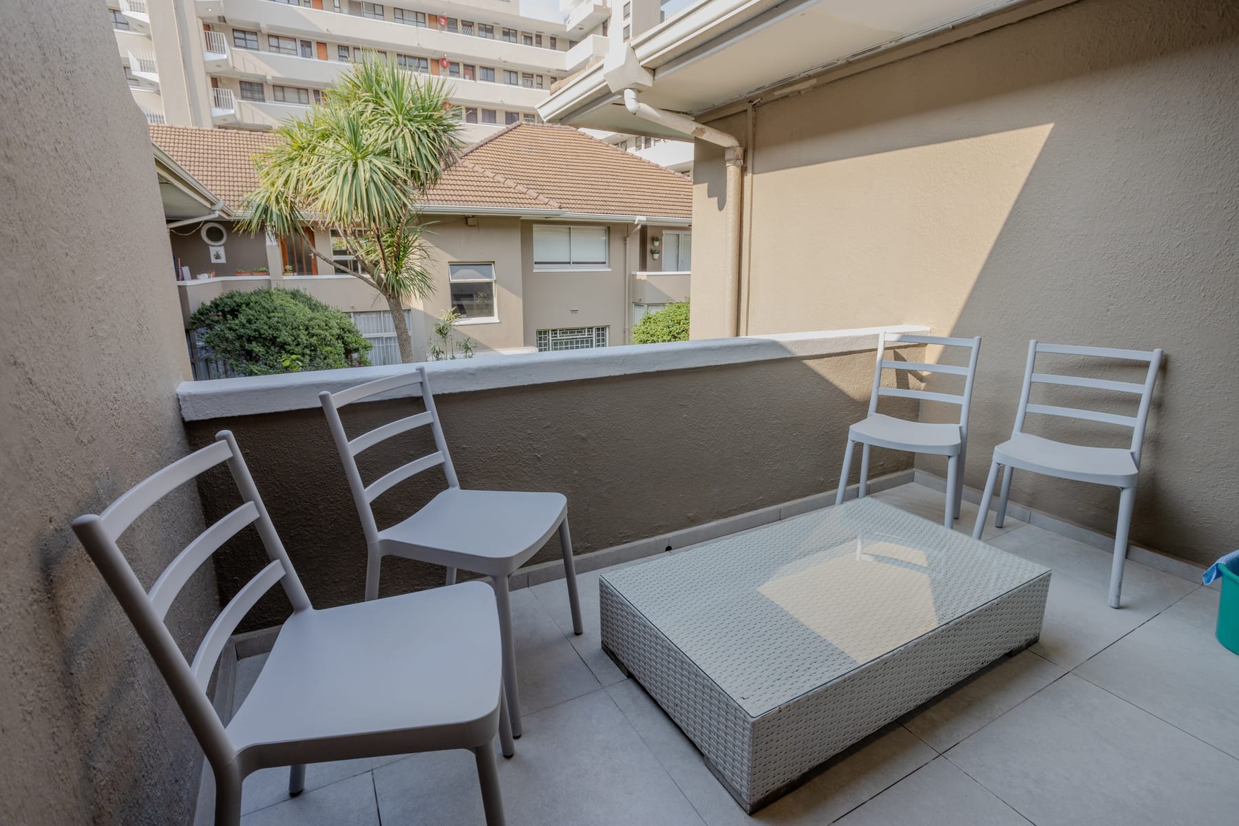 Private balcony with outdoor seating overlooking the courtyard