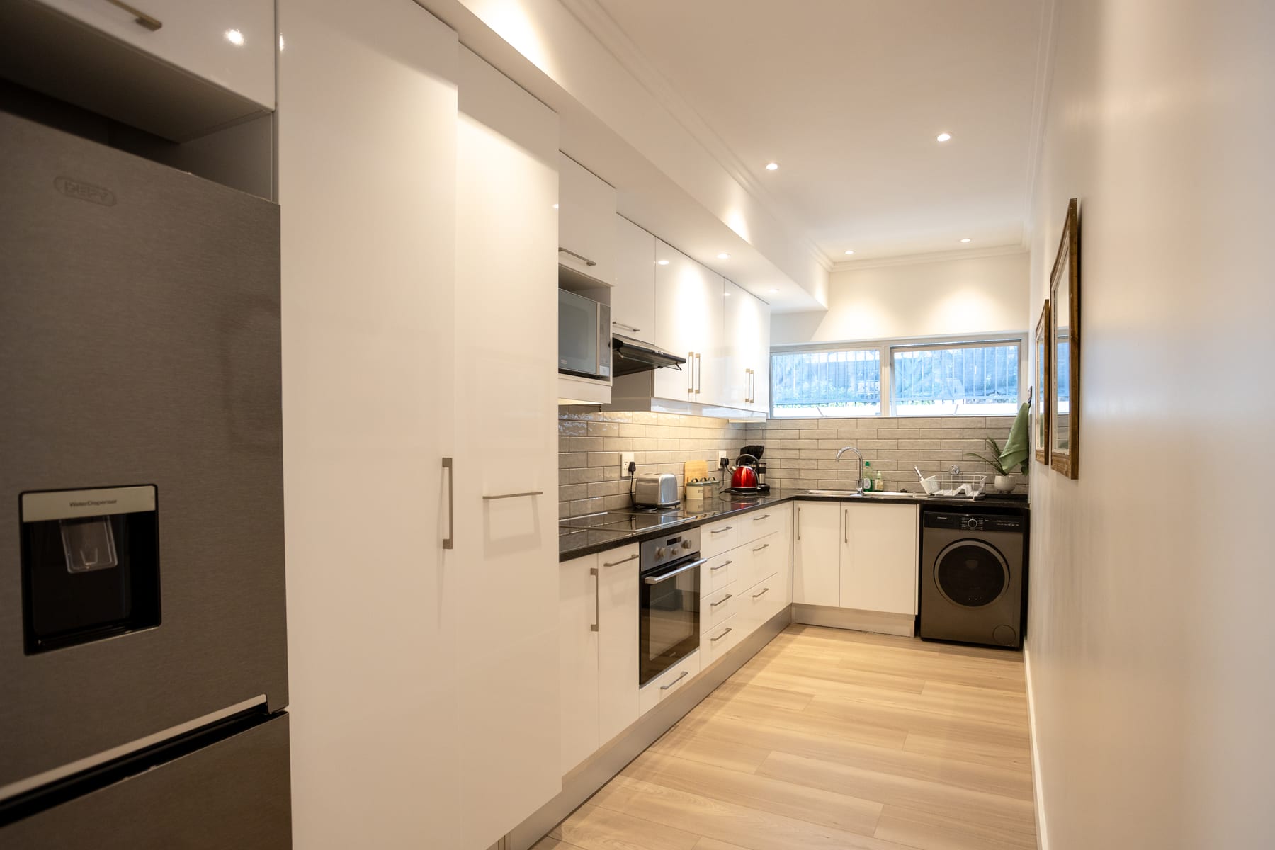 Fully equipped kitchen with an oven, fridge and washing machine