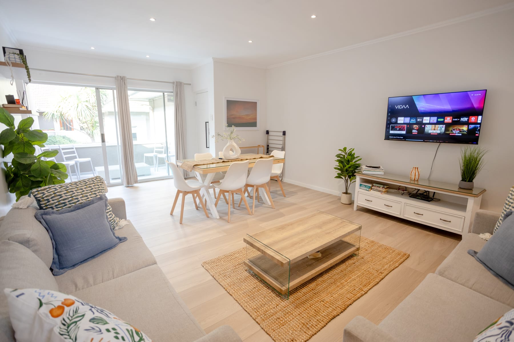 Renovated living and dining room opening onto the private balcony