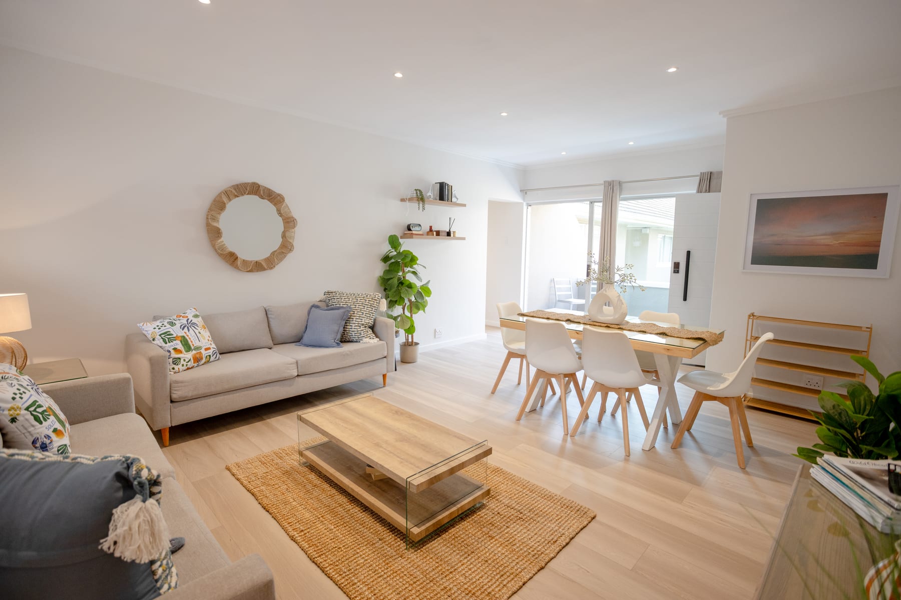 Bright living room and dining area with balcony access