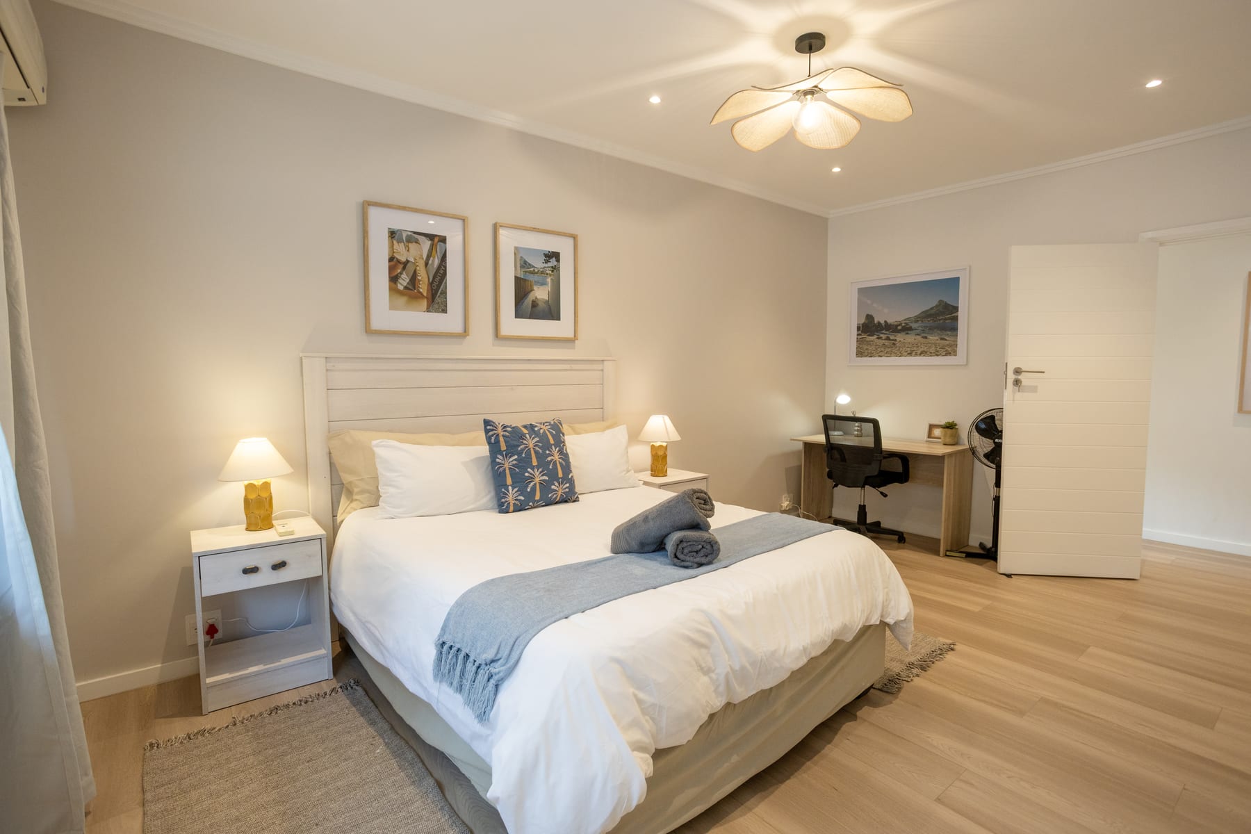 Main bedroom with a queen bed and dedicated workspace