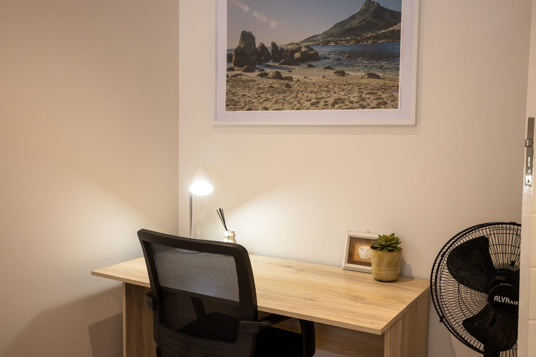 Dedicated desk with an office chair and task lamp